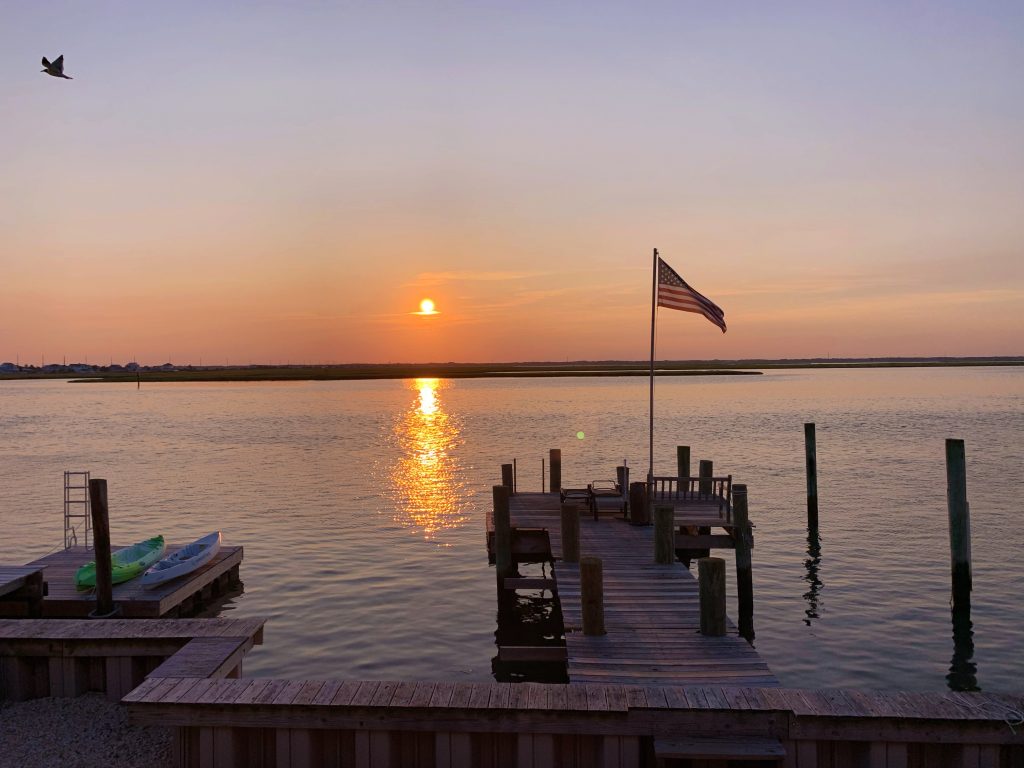 tranquil sunset by a dock on the bay in stone harbor