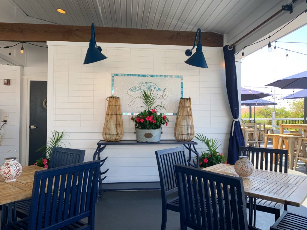 surfside rooftop grill sign and blue chairs