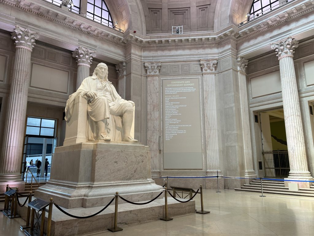 statue of benjamin franklin seated in the entrance hall of the ben franklin museum