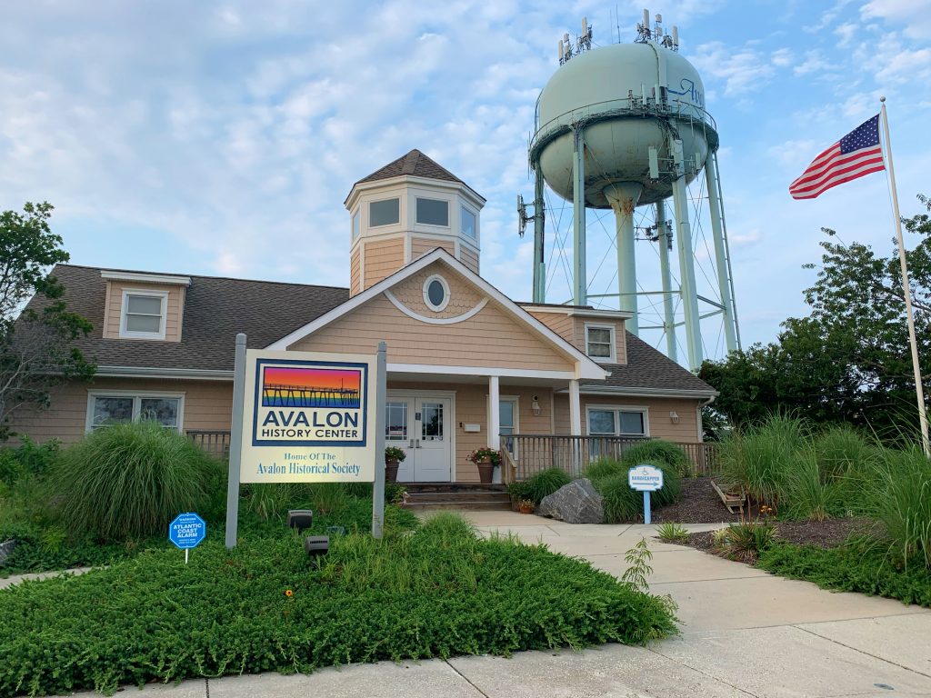 tan building in front of water tower