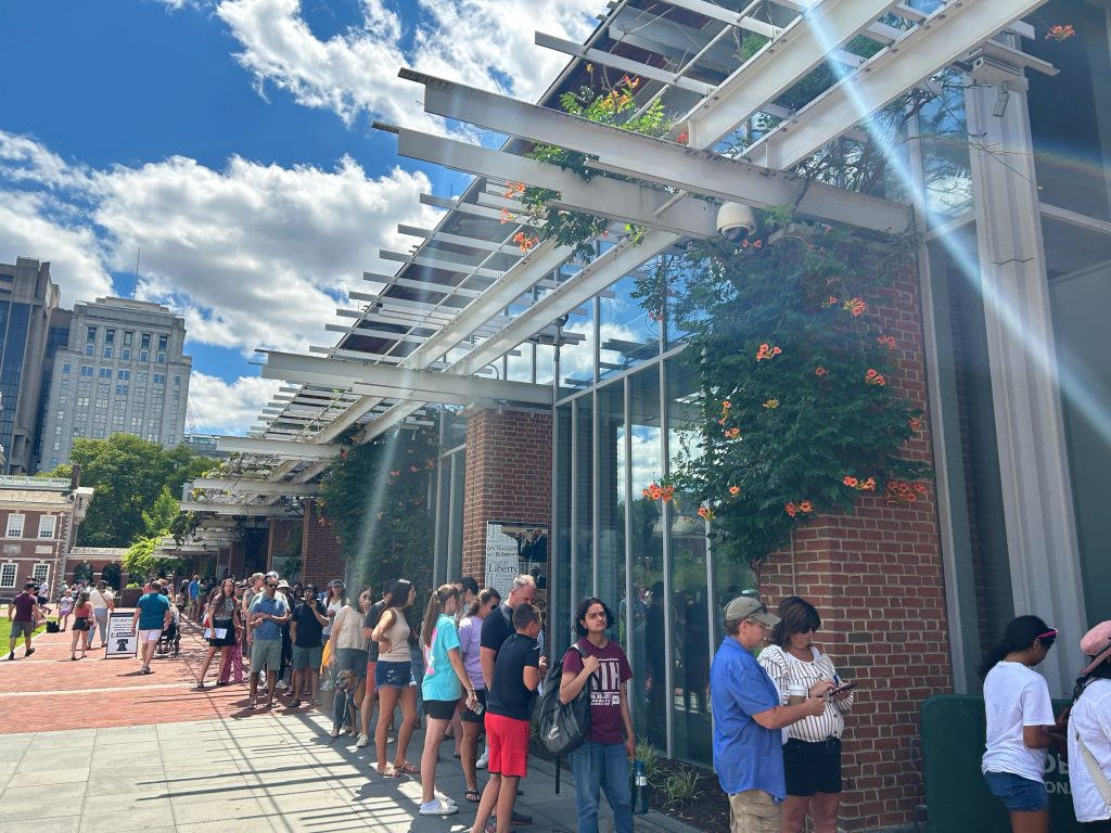 long line of people outside the building that houses the liberty bell
