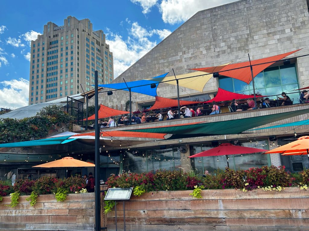 outdoor seating at liberty point with colorful rain covering