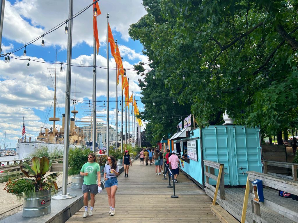 light blue food stand along walking path at penn's landing