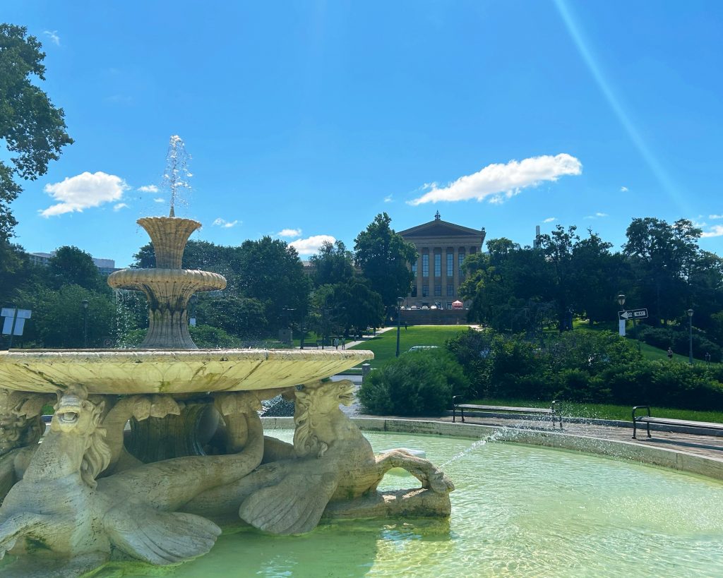 clear water fountain in front of the philadelphia art museum lawn