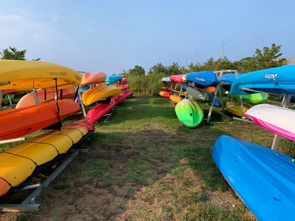 racks of colorful kayaks
