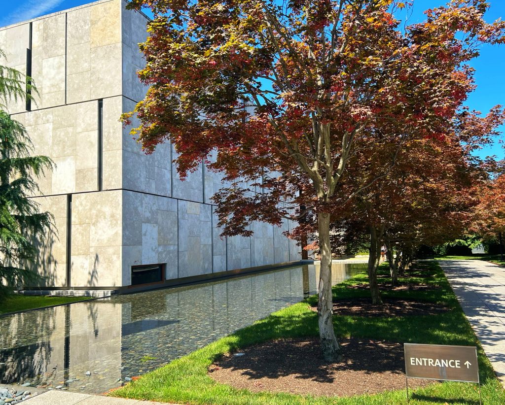 rectangular pond outside of the barnes foundation next to red leafed tree