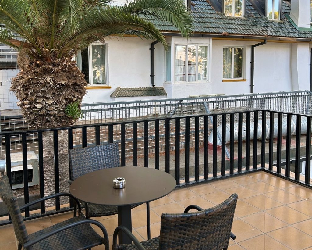 balcony with a table and three chairs