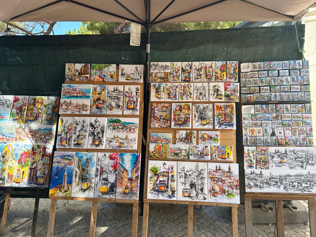 colorful canvas paintings for sale on the street in lisbon