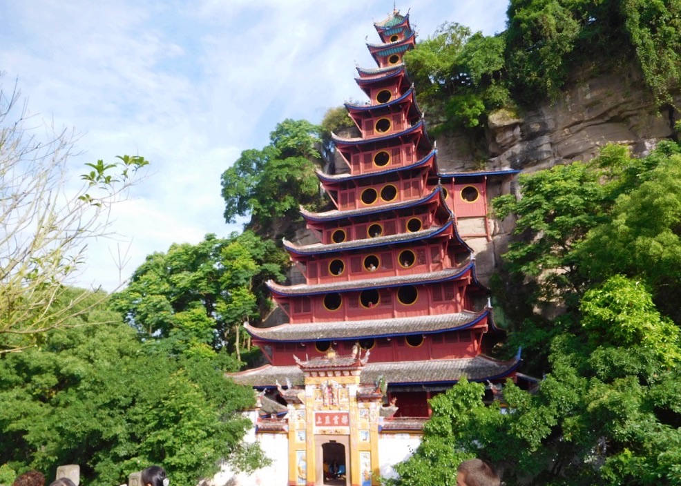 many red tiers of the shibaozhai pagoda surrounded by green trees