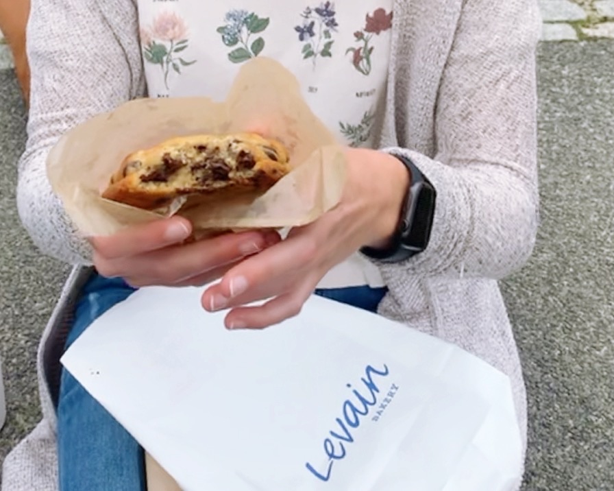 girl holding a levain cookie