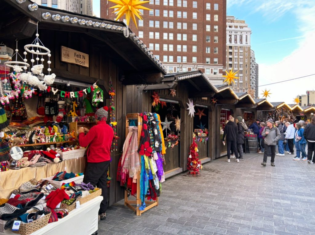 wooden open air local shops at the Philadelphia Christmas Village full of scarves and christmas gifts
