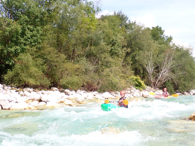 girl kayaking through white water river