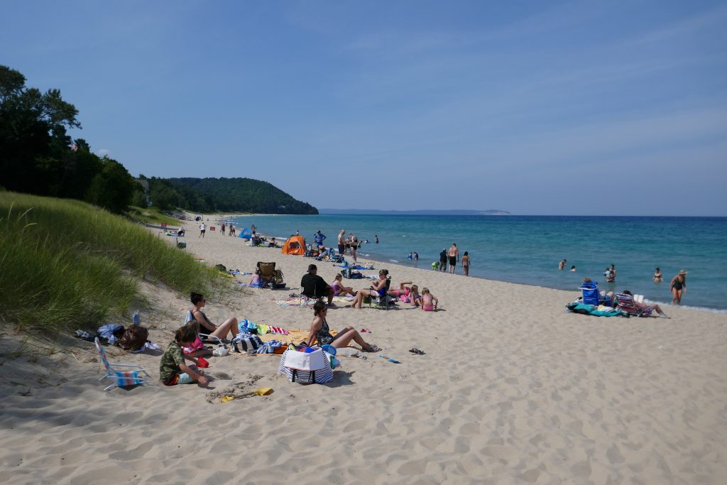 people sitting on beach on nice day