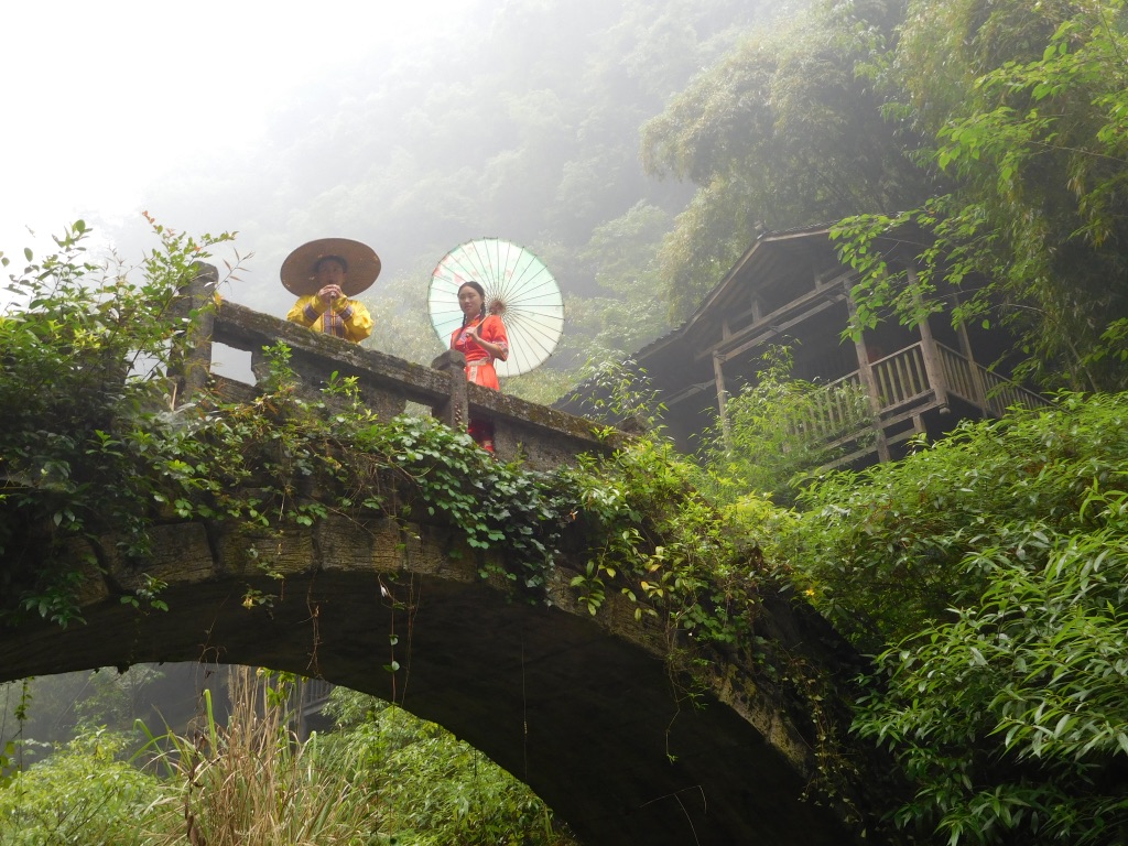 romantic couple on Tribe of the Three Gorges on bridge