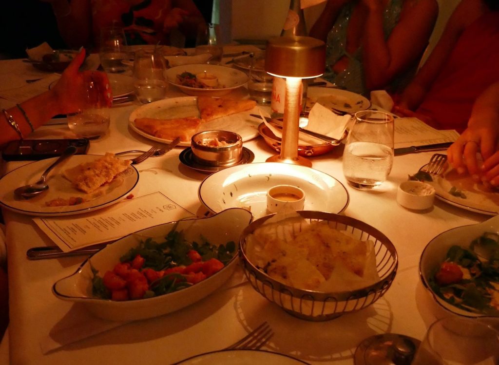 appetizers on a table with a small lamp