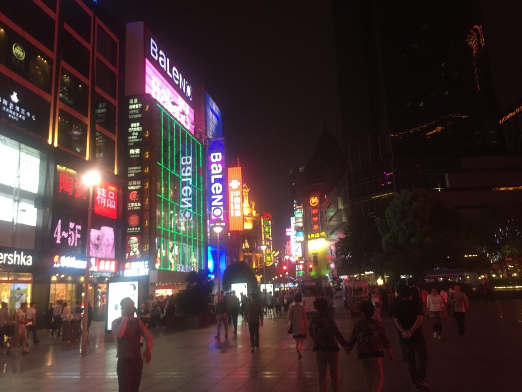 city street at night with lit up buildings