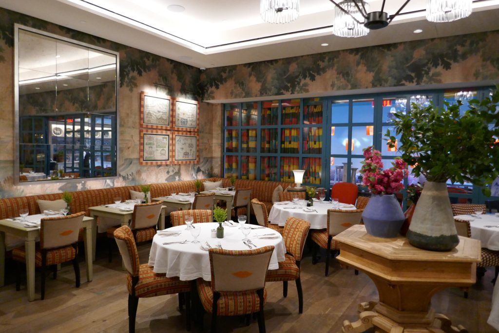 colorful restaurant with no people in it and flowers on table