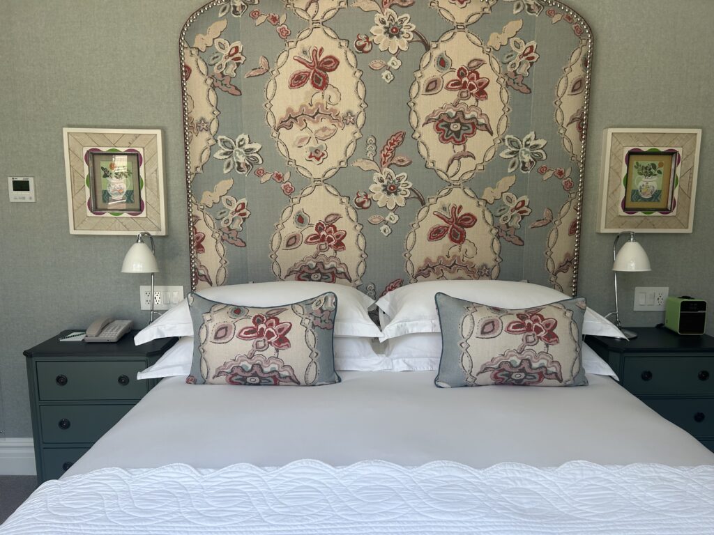 patterned pillows with matching headboard and photo frames