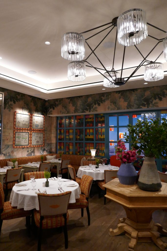 corner of restaurant with flowers and book shelves