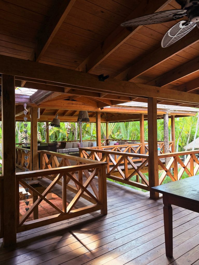 wooden deck with rails and covered overhangs