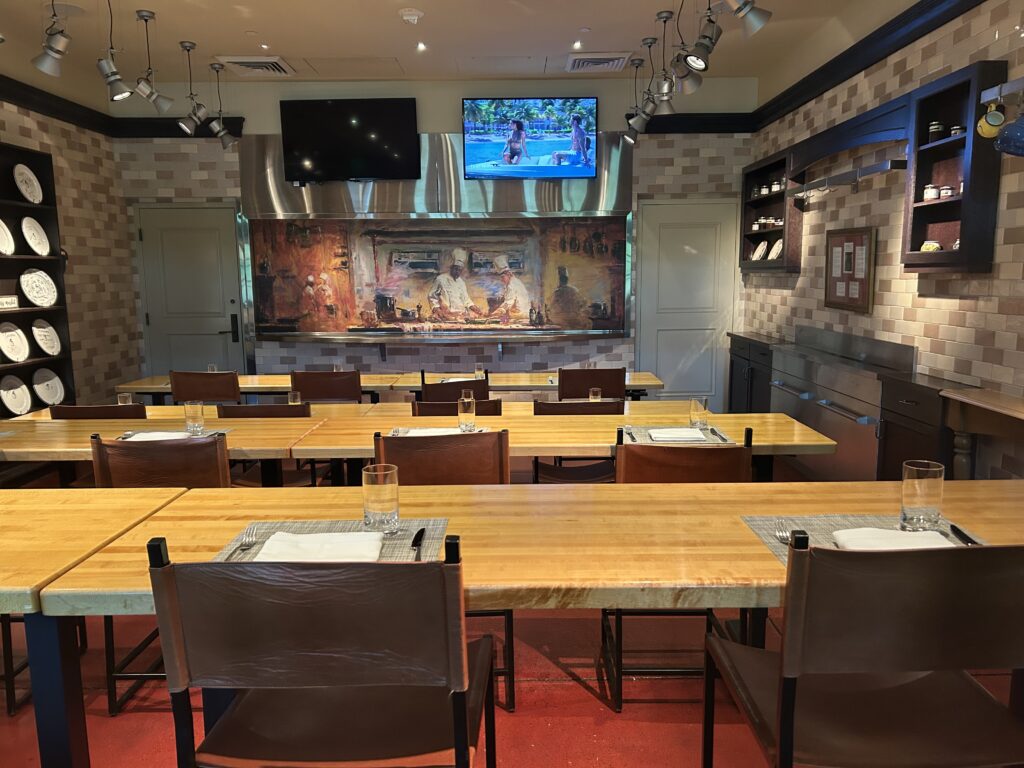 rows of cooking tables set up with placemats in a classroom