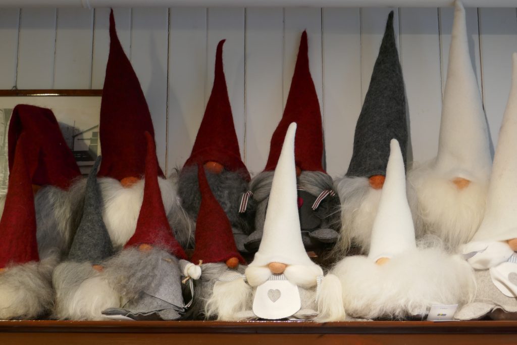 tomtes and gnomes with tall traingular hats on a shelf