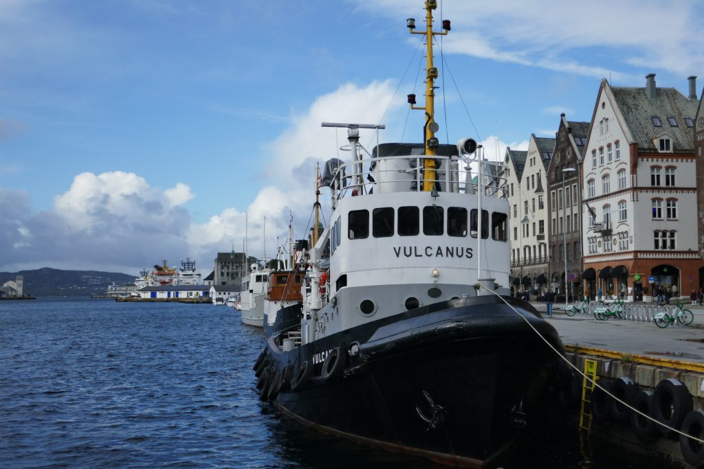 a boat called the vulcans docked at a pier in bergen